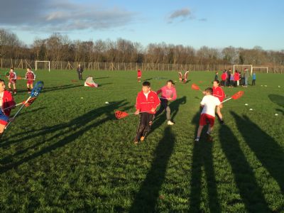 Children playing pop Lacrosse